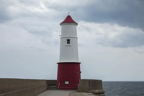 Simple plain red and white painted lighthouse Stock Photos