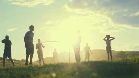 Simple poor farmer boys playing football on the background of a bright sunset  Stock Footage 64638775