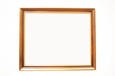 Simple profiled wooden frame on a light background Stock Photos