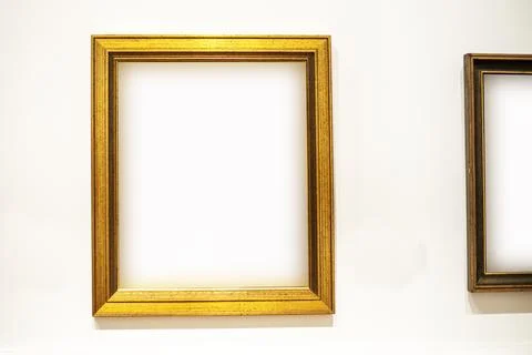 Simple profiled wooden frame on a light background Stock Photos