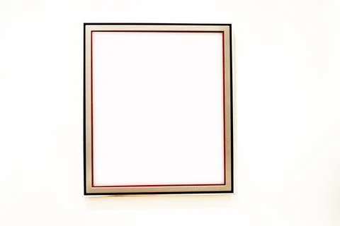 Simple profiled wooden frame painted white with black and red stripes on a .. Stock Photos
