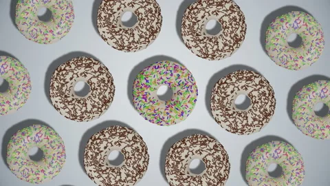 Simple rotation pattern of white donuts with sprinkles on white background Stock Footage 196484788