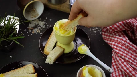 Simple rustic breakfast with soft-boiled egg in a special egg cup and bread Stock Footage 134022349