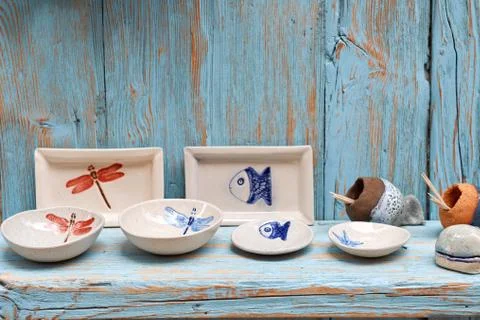 Simple rustic kitchenware against blue wooden wall : Pretty ceramic dishes Stock Photos