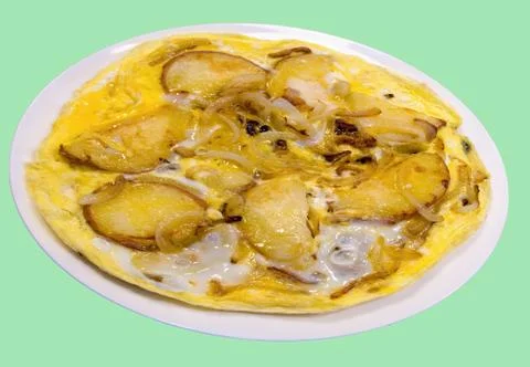 A simple rustic scrambled eggs with potatoes and onions. Stock Photos