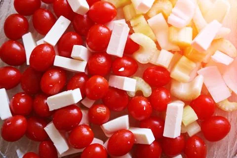 A simple salad for a healthy diet. Cherry tomatoes, celery and slices of chee Stock Photos