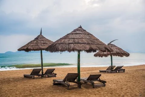 Simple scene with straw umbrella Stock Photos