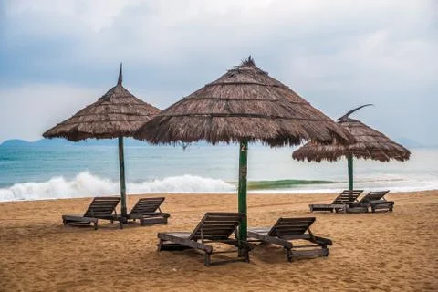 Simple scene with straw umbrella Stock Photos