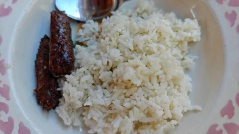 Simple Serving of Steamed White Rice with Fried Side Dish on Plate Stock Photos