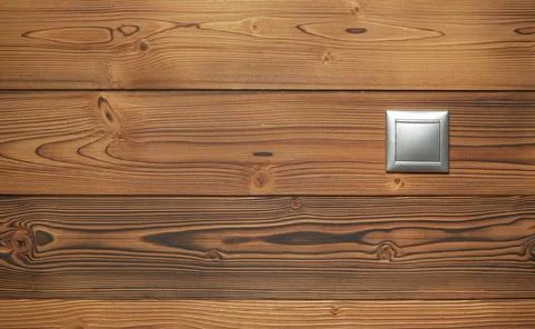 Simple silver coloured plastic light switch on wooden boards wall Stock Photos