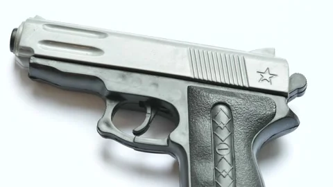 A simple small cheap plastic fake realistic toy gun prop object detail clos.. Video stock 228883471
