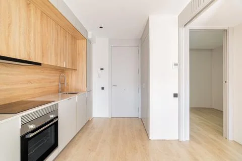 Simple small modular kitchen area along the wall in studio apartment next to Фото