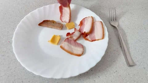 Simple Snack Scene: Bacon and Cheese on White Plate, Fork Nearby 스톡 동영상 320284882