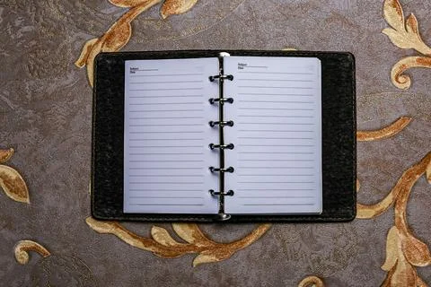 Simple spiral-bound notebook with lined paper beside a single on a clean Stock Photos
