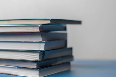 Simple stack of books on the shelf at home Stock Photos