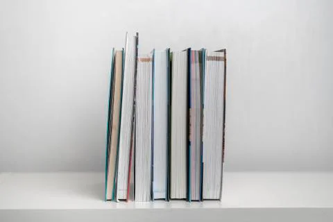 Simple stack of books on the shelf at home Stock Photos