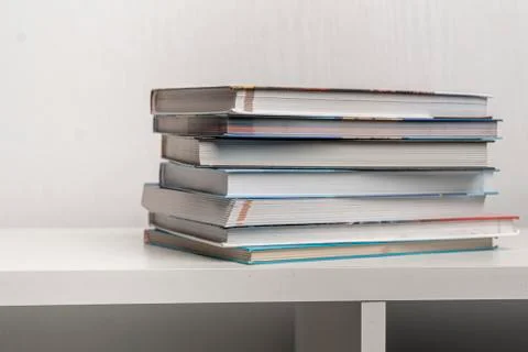 Simple stack of books on the shelf at home Stock Photos