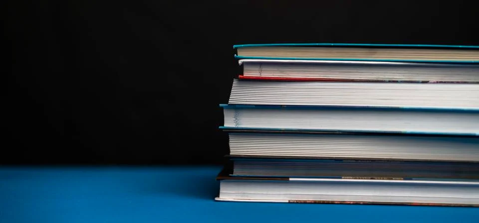 Simple stack of books on the shelf at home Stock Photos
