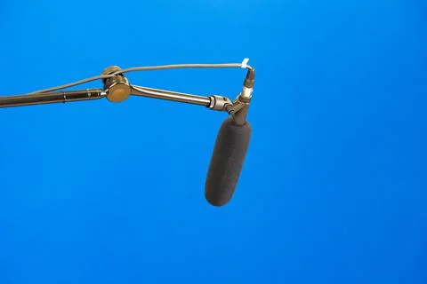 A simple studio microphone on a mic arm, bluescreen, blue box chroma key Stock Photos