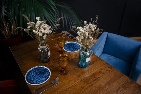 Simple table setting with flowers on dark background Stock Photos