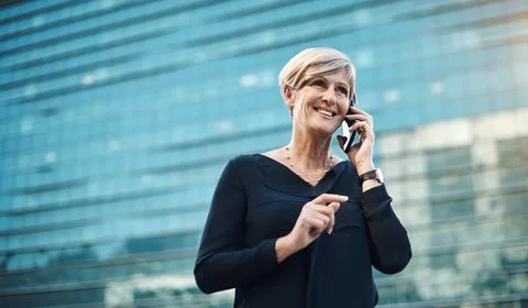 The simple way to touch base with clients. a mature businesswoman using a Stock Photos