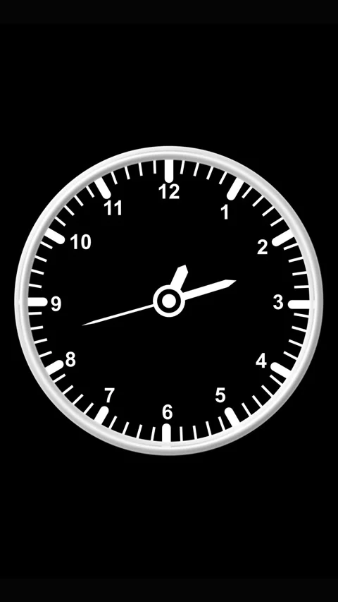 A simple white analog clock face with black background and white hands show.. Stock Footage 344859659