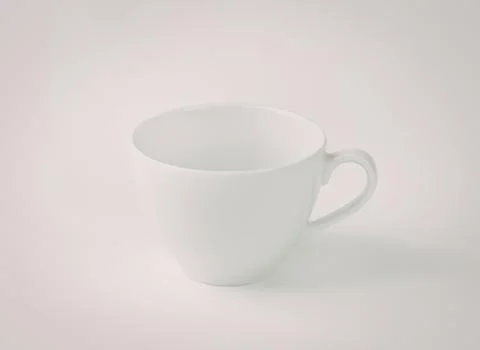 Simple white ceramic coffee cup with handle Photos