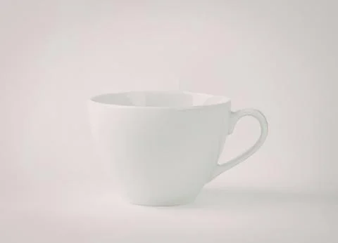 Simple white ceramic coffee cup with handle Photos