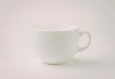Simple white ceramic coffee cup with handle Photos