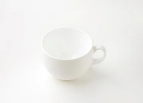 Simple white ceramic coffee cup with handle Photos