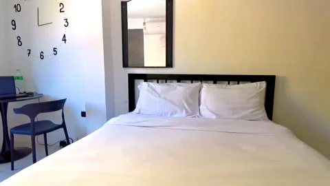 Simple white cheap hotel apartment room bed table chairs Thailand. Stock Footage 337018757
