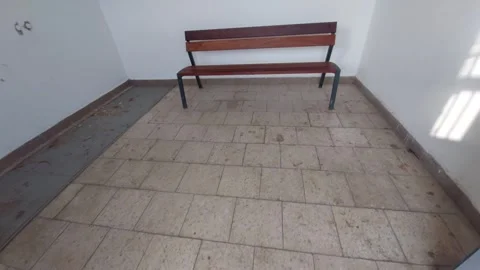 Simple Wooden Bench in Empty Train Station Waiting Room Stock Footage 334177562