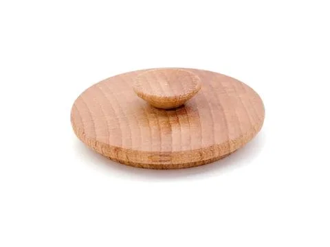 Simple wooden button with a rounded shape and natural wood color Stock Photos