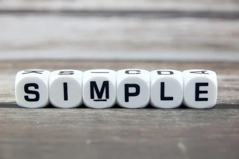 Simple wording  or text on white dice with black wooden background.Copy spa.. Stock Photos