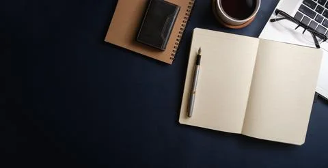 Simple working desk with laptop computer, coffee cup, notebook and table. T.. Stock Photos