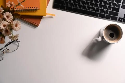 Simple workplace with keyboard, coffee cup, glasses and notebook. Flat lay, Top Stock Photos