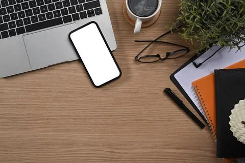 Simple workplace with laptop computer, mobile phone, glasses and coffee cup. Top Stock Photos