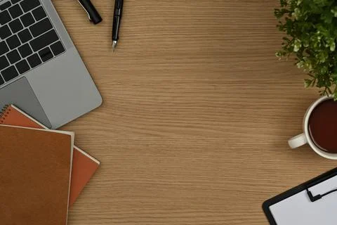 Simple workplace with laptop computer, notepad, clipboard and coffee cup on Stock Photos