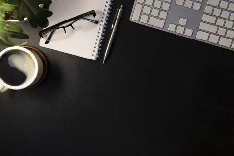 Simple workplace with notebook, coffee cup, glasses and potted plant. Flat .. Stock Photos