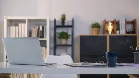 Simple workspace with laptop, notebooks, coffee cup and pencil holder on wh.. Stock Photos