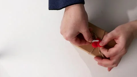 Simple Wrapping of Valentines Day Gift With Jute String and Red Heart on White 库存影片 323165619