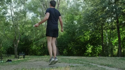 A simple yet effective way to stay healthy: a man exercises with a jump rope Stock Footage 303818124