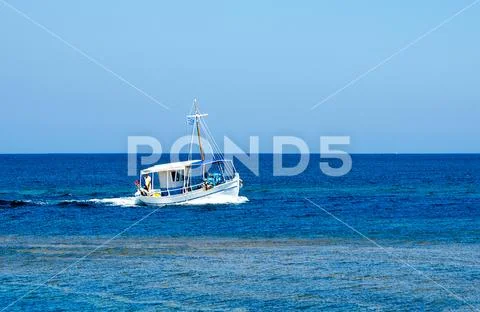 Simplicity and variations of blue colour on this image with the small fishing Stock Photos