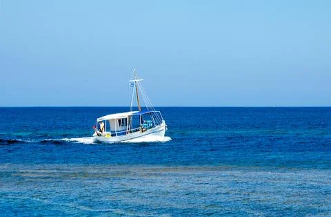 Simplicity and variations of blue colour on this image with the small fishing Stock Photos