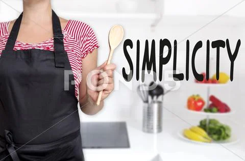 Simplicity cook holding wooden spoon concept background Stock Photos