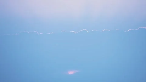 The simplicity of the horizon where a line of delicate clouds is silhouetted Video stock 276403084