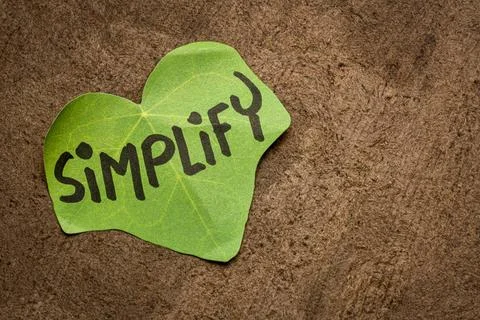 Simplify reminder note simplify reminder - handwriting on a leaf shaped no... Stock Photos