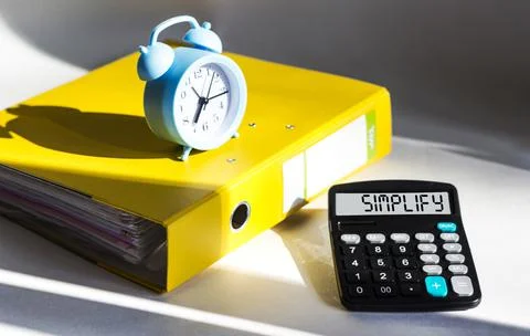 Simplify, word on calculator display. Brainstorming planning Stock Photos