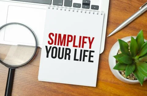 Simplify Your Life writing text post it paper in office on laptop computer ke Stock Photos