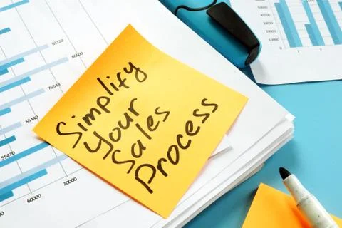 Simplify Your Sales Process written on the page. Stock Photos